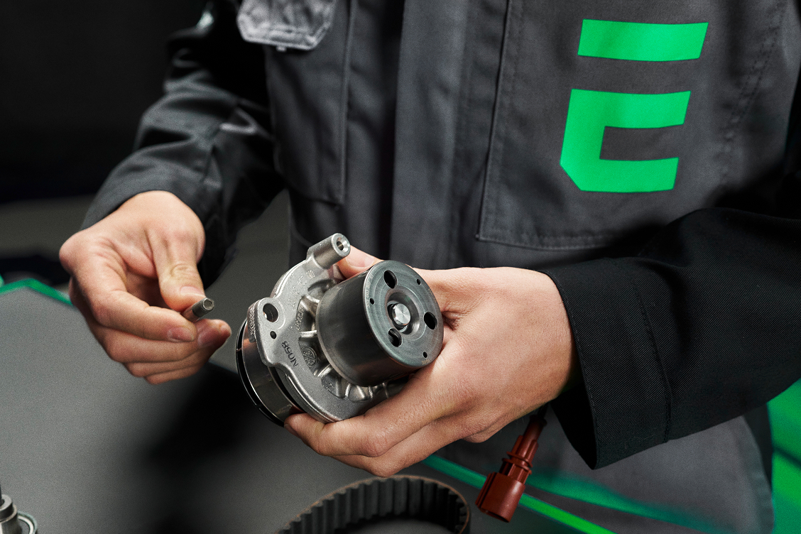 Man holding car part